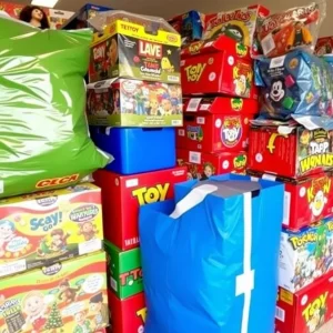 Colorful toy donations stacked for holiday charity drive.