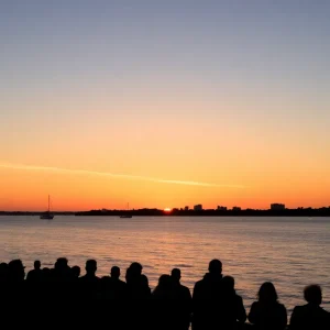 Sunset over Tampa Bay with community gathering